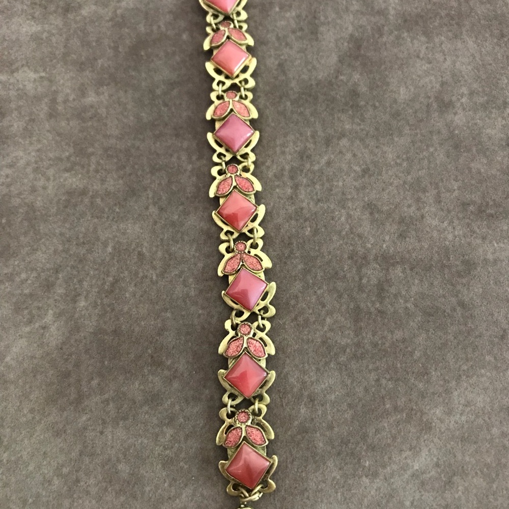 Gold bracelet with pink stones